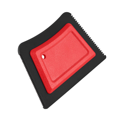 Angled view of the red hair remover showing its textured grip and cleaning edge